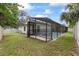 Backyard view featuring a screened-in pool area, offering a relaxing and private outdoor space at 6706 Dunes Ln, Temple Terrace, FL 33617