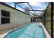 Inviting in-ground swimming pool with a screened enclosure, perfect for year-round enjoyment at 6706 Dunes Ln, Temple Terrace, FL 33617