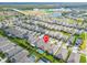 An aerial view of a residential area with a home marked by a location pin with nearby community lake and highways at 7408 Sungold Meadow Ct, Apollo Beach, FL 33572