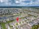 Wide aerial shot of a neighborhood with homes situated near ponds and scenic landscaping marked by a location pin at 7408 Sungold Meadow Ct, Apollo Beach, FL 33572