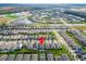 An aerial view of a residential area with a home marked by a location pin, surrounded by community features at 7408 Sungold Meadow Ct, Apollo Beach, FL 33572