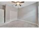 Inviting bedroom featuring a neutral color scheme, plush carpeting, and ample closet space at 7408 Sungold Meadow Ct, Apollo Beach, FL 33572