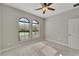 This bedroom offers large windows, allowing plenty of natural light, and features carpet flooring at 7408 Sungold Meadow Ct, Apollo Beach, FL 33572