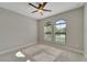 This bedroom is brightened by natural light and features carpet flooring and a modern ceiling fan at 7408 Sungold Meadow Ct, Apollo Beach, FL 33572