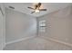 Bright bedroom with neutral decor, ceiling fan, and window letting in natural light at 7408 Sungold Meadow Ct, Apollo Beach, FL 33572