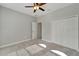 This bedroom features neutral walls, plush carpet, and ample closet space, with a ceiling fan for added comfort at 7408 Sungold Meadow Ct, Apollo Beach, FL 33572