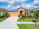 Charming single-Gathering home with a well-manicured lawn, mature landscaping, and a two-car garage at 7408 Sungold Meadow Ct, Apollo Beach, FL 33572