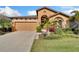 Charming single-story home featuring a two-car garage and well-maintained landscaping at 7408 Sungold Meadow Ct, Apollo Beach, FL 33572
