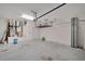 Spacious garage with overhead storage, utility door, and visible mechanical systems at 7408 Sungold Meadow Ct, Apollo Beach, FL 33572