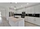 Well-lit kitchen boasting stainless steel appliances, white cabinetry, and a center island at 7408 Sungold Meadow Ct, Apollo Beach, FL 33572