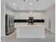 Modern kitchen with stainless steel appliances, a center island, and sleek, white cabinetry at 7408 Sungold Meadow Ct, Apollo Beach, FL 33572