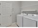 A functional laundry room equipped with modern appliances and convenient shelving for storage solutions at 7408 Sungold Meadow Ct, Apollo Beach, FL 33572