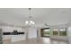 Expansive open-concept living space with sleek kitchen island, stainless appliances, and pool views, perfect for gatherings at 7408 Sungold Meadow Ct, Apollo Beach, FL 33572