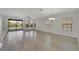 Bright living room with wood floors, multiple windows, and sliding glass doors to the backyard at 7408 Sungold Meadow Ct, Apollo Beach, FL 33572