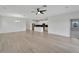 Bright open-concept living room and kitchen featuring light wood floors and modern accents at 7408 Sungold Meadow Ct, Apollo Beach, FL 33572