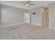 Large primary bedroom with carpet, ceiling fan, recessed lighting and doors to an ensuite at 7408 Sungold Meadow Ct, Apollo Beach, FL 33572