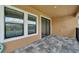 Covered patio features tiled flooring, windows and sliding doors to the interior at 7408 Sungold Meadow Ct, Apollo Beach, FL 33572