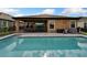 Backyard pool with patio area, lush landscaping, and screened enclosure at 7408 Sungold Meadow Ct, Apollo Beach, FL 33572