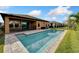 Inviting backyard pool with modern paved deck, secured with a fence, and lush green lawn at 7408 Sungold Meadow Ct, Apollo Beach, FL 33572