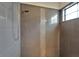 Close up of gray tile, shower head, and glass enclosed shower at 7408 Sungold Meadow Ct, Apollo Beach, FL 33572
