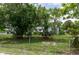 Fenced backyard with mature trees offering shade and privacy, creating a peaceful outdoor space at 760 72Nd N Ave, St Petersburg, FL 33702