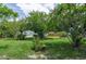 Spacious backyard featuring mature trees and lush landscaping, perfect for outdoor activities at 760 72Nd N Ave, St Petersburg, FL 33702