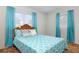 Cozy bedroom featuring a blue patterned bedspread and bright natural light at 760 72Nd N Ave, St Petersburg, FL 33702