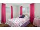 Bedroom with pink curtains, bedspread and bright natural light at 760 72Nd N Ave, St Petersburg, FL 33702