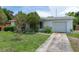 Charming single-story home featuring a well-maintained lawn, mature trees and landscaping at 760 72Nd N Ave, St Petersburg, FL 33702
