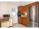 Functional kitchen featuring wooden cabinets, appliances, and bright natural light at 760 72Nd N Ave, St Petersburg, FL 33702