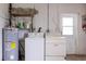 Functional laundry area equipped with washer, dryer, and utility sink at 760 72Nd N Ave, St Petersburg, FL 33702