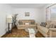 Comfortable living room featuring a cozy sofa, plush armchair and large decorative pillows at 760 72Nd N Ave, St Petersburg, FL 33702