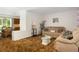 Comfortable living room featuring a cozy sofa, plush armchair and large decorative pillows at 760 72Nd N Ave, St Petersburg, FL 33702
