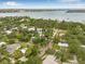 Beautiful aerial view of a home nestled amongst lush trees with a bay view at 8010 Par N Ave, St Petersburg, FL 33710