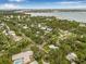An aerial view shows the property's location in a lush, desirable neighborhood with waterfront access at 8010 Par N Ave, St Petersburg, FL 33710