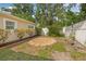 A cozy backyard featuring a brick-lined fire pit and a well-maintained privacy fence at 8010 Par N Ave, St Petersburg, FL 33710