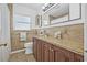 A bathroom showcases a granite vanity with a framed mirror and decorative tile work at 8010 Par N Ave, St Petersburg, FL 33710