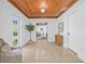 Inviting entryway featuring a wood-paneled ceiling, tile flooring, and a view into the living spaces at 8010 Par N Ave, St Petersburg, FL 33710