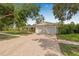 Inviting home exterior featuring a well-maintained lawn and a spacious brick driveway leading to a two-car garage at 8010 Par N Ave, St Petersburg, FL 33710
