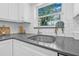 Modern kitchen boasts gray countertops, stainless steel sink, and bright natural lighting at 8010 Par N Ave, St Petersburg, FL 33710