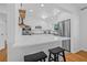 Bright kitchen with white cabinets, stainless steel appliances, and a breakfast bar featuring barstool seating at 8010 Par N Ave, St Petersburg, FL 33710
