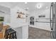 Modern kitchen featuring white cabinetry, stainless steel appliances, and a breakfast bar with seating at 8010 Par N Ave, St Petersburg, FL 33710