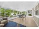 Relaxing lanai with tiled floor, patio furniture and views of the lushly landscaped backyard at 8010 Par N Ave, St Petersburg, FL 33710