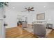 Bright living room with hardwood floors, neutral furniture, ceiling fan, and view of dining room at 8010 Par N Ave, St Petersburg, FL 33710
