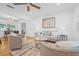 Open concept Living Room features hardwood floors, lots of natural light and ceiling fan at 8010 Par N Ave, St Petersburg, FL 33710