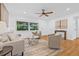 Light-filled living room with wood floors, neutral decor, a ceiling fan, and a large window at 8010 Par N Ave, St Petersburg, FL 33710