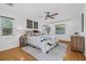 Serene main bedroom featuring hardwood floors, ceiling fan, and plenty of natural light at 8010 Par N Ave, St Petersburg, FL 33710