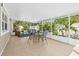 Relaxing covered patio featuring tile floors, modern furniture, and bright views of the backyard at 8010 Par N Ave, St Petersburg, FL 33710
