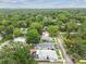 Aerial view showcasing the property in a lush, tree-filled neighborhood at 904 E Hamilton Ave, Tampa, FL 33604