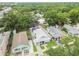 An aerial view showcasing the home's proximity to lush greenery and a pool at 904 E Hamilton Ave, Tampa, FL 33604
